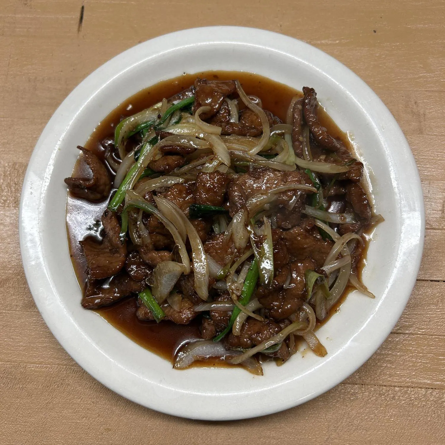 Beef with Scallions features tender beef slices stir - fried with scallions and onions in a savory sauce at Asian Wok, a Chinese restaurant in Port Lavaca