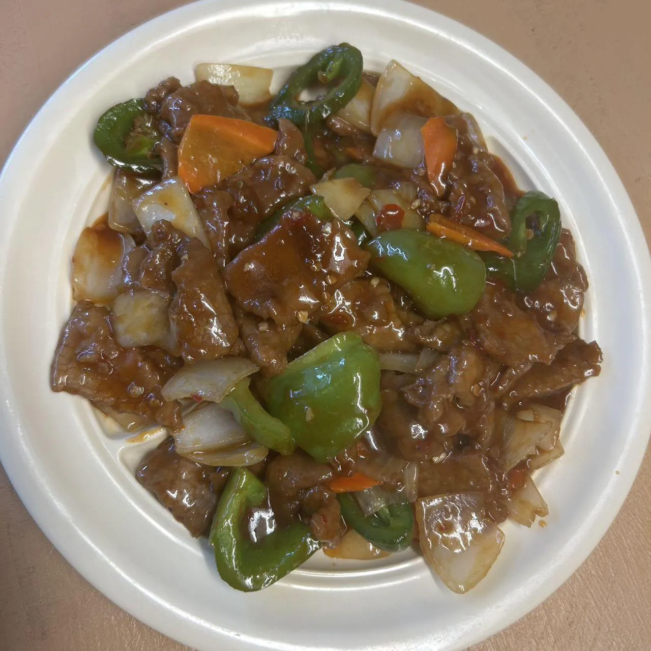 Beef with Green Peppers features tender beef slices stir - fried with green peppers, onions, and carrots in a savory sauce at Asian Wok, a Chinese restaurant in Port Lavaca