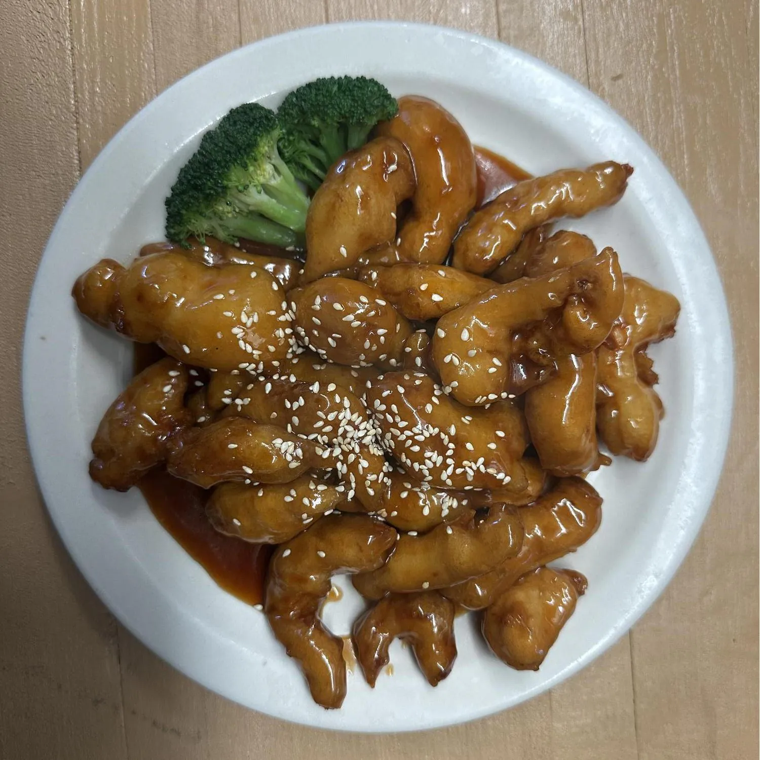 Sesame Chicken features tender chicken pieces coated in a savory sauce and sprinkled with white sesame seeds at Asian Wok, a Chinese restaurant in Port Lavaca