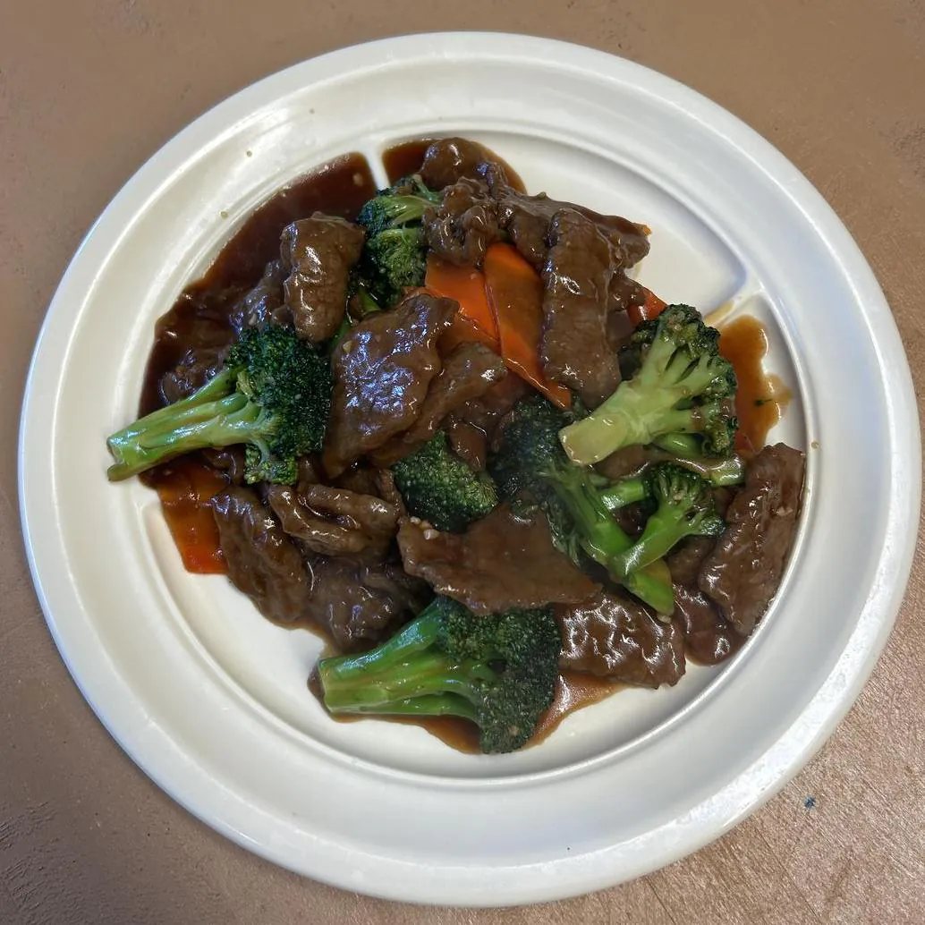 Beef with Broccoli features tender beef slices stir - fried with broccoli and carrots, all coated in a savory sauce at Asian Wok, a Chinese restaurant in Port Lavaca